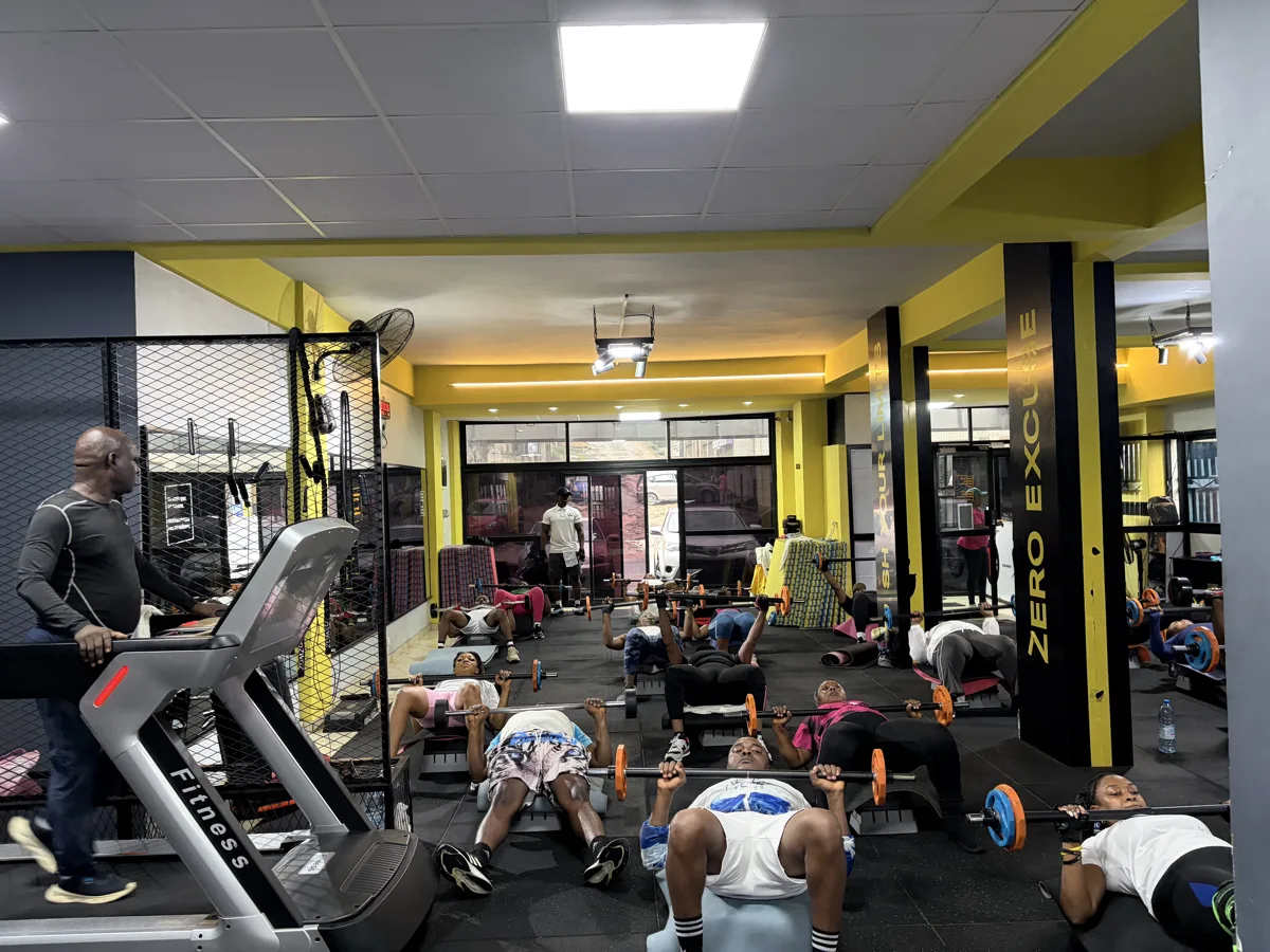 Rameur haut de gamme aux accents jaunes dans une salle sombre.